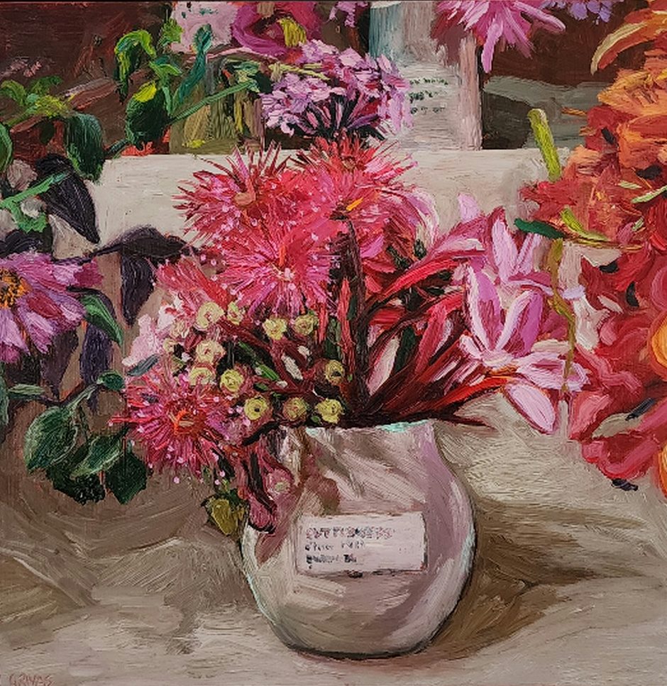 Oil painting. Pretty pink flowering gum and pink frangipani arranged in a cream rounded ceramic squat vase. Surrounded by sections of other flower exhibits. Childrens section, 'Flowers from my Garden' at Berry Show 2025